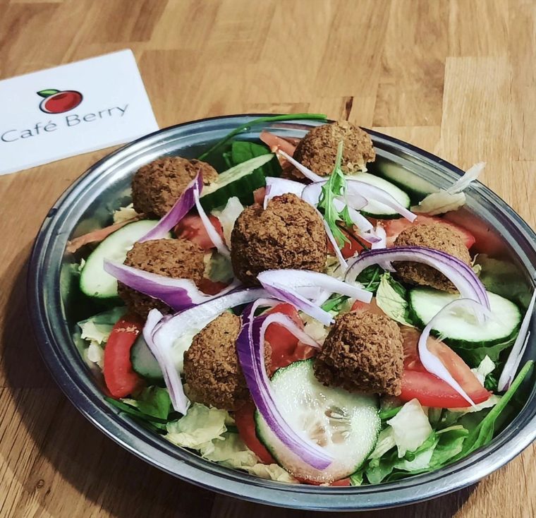 Falafel over a bowl of green salad